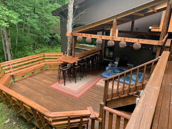 back deck for your fun times, bar, floating high table and surround seating