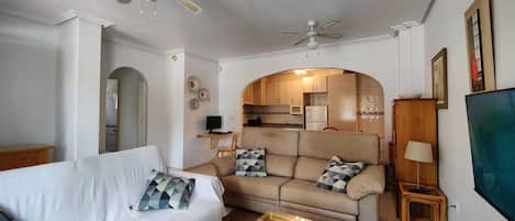 Living room with wall-mounted collapsible desk in the background