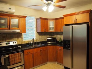 Updated kitchen with granite counter tops and stainless steel appliances