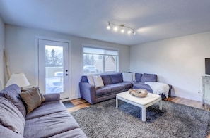 Large living room with incredible views of Rundle and Ha Ling mountain peaks.