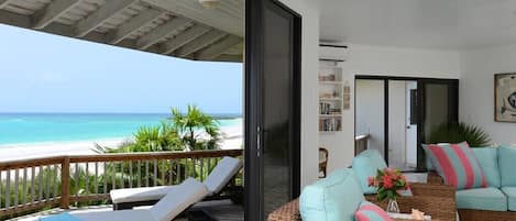 Living room with sliding glass wall to sun deck