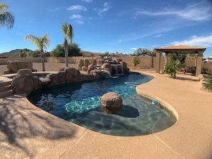 Pool with waterfalls and gazebo.