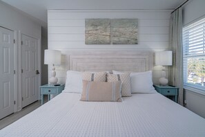 Lamps on each side of the king bed with new fan and TV