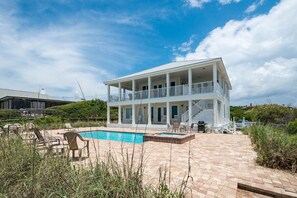 The pool/spa with the balcony and porch as seen from the private dune walkover.