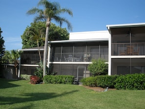 Looking up to lanai from grassy area (second from left by palm, upstairs)