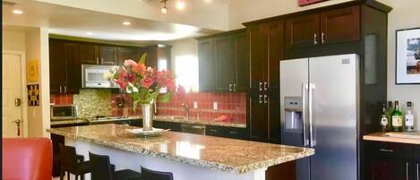 Kitchen 16 foot granite island condo is 1200 sq ft 2bed 3 bth Upper Unit. Quiet 