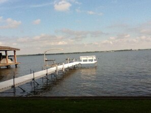 Pier with bench, swim ladder and boat lift. Sandy bottom and 2 ft deep at end of pier