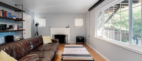 Bright living room with Restoration Hardware leather sofa.