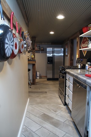 Galley kitchen stocked with all modern appliances and a dish washer. 