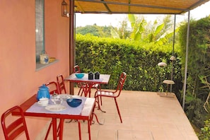 Private outdoor patio surrounded by the gardens.