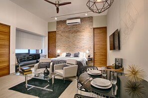 Tall ceilings, exposed brick, contemporary decor - window looks out to courtyard