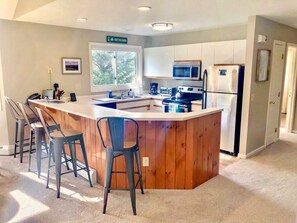 Kitchen is fully stocked for all your cooking needs and offers stainless steel appliances, drip coffee maker and breakfast bar that seats 4.