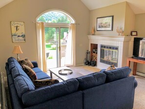 The living room with a cozy wood burning fireplace.