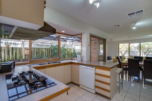 Kitchen view facing alfresco area