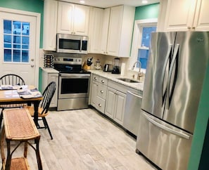 NEW kitchen withttps://app.guesty.com/reservationsh quartz counter tops, stainless steel appliances and beach-wood style tile floors.