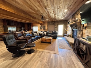 Wide view of lower level family room with walkout to porch.
