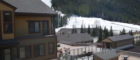 Views from condo & deck of ski school, slopes, hot tubs, fire pit, club house.