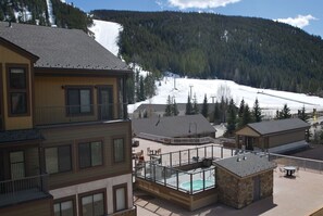 Views from condo & deck of ski school, slopes, hot tubs, fire pit, club house.