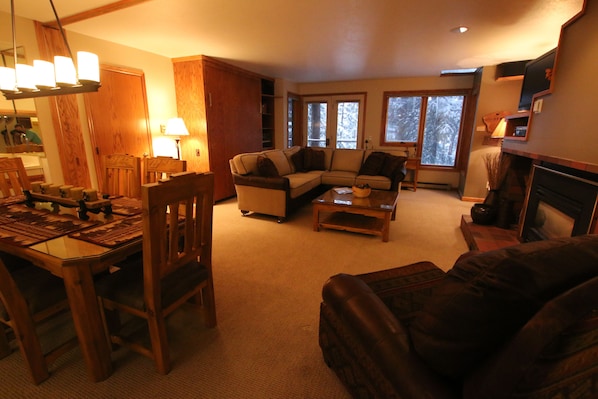 Living room, dining table and murphy bed (in-wall). Room divider retracted.