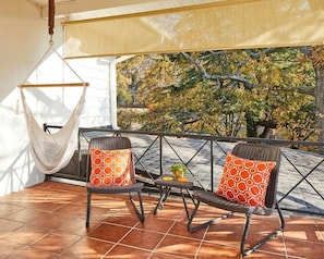 The large balcony with a downtown view is a great place to enjoy the sunrise or sunset. Relax in the hammock chair or do morning yoga on the terrace. Pull down shades provide privacy or sun protection. 