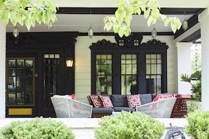 Step outside the apartment to the front porch. Enjoy a cocktail on the lounge sofa while you overlook the property's front garden.