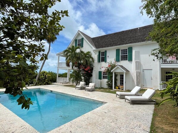 Buccaneer Hill sits high on a hilltop overlooking Governors Harbour and the Caribbean Sea beyond.