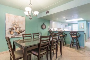 The dining table seats six with extra seating at the kitchen bar.