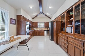Large Kitchen with table and chairs for in kitchen dining. 