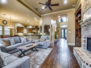 The living room flows into the gourmet kitchen, bar, and breakfast nook