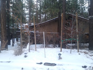 Front of cabin with December snow