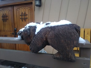 Snow-covered bear to welcome you to the cabin.