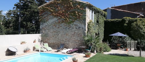 Traditional stone cottage and sun-drenched swimming pool in heart of France. 