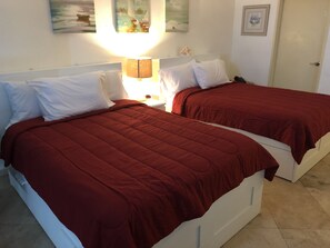 Two, very modern, full size beds with 4 drawers on each size for storage