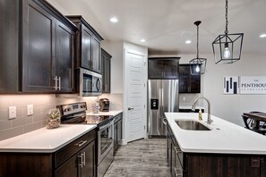 Kitchen - The kitchen is fully stocked with all the dishes, cookware, baking pans, and cutlery you will need for meal preparations and includes stainless steel appliances and granite counter tops.