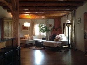 Living Room with Kiva, wood floors and vigas