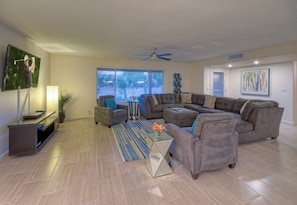 Great room has lots of comfortable seating for friendly conversations or watching the large smart TV.