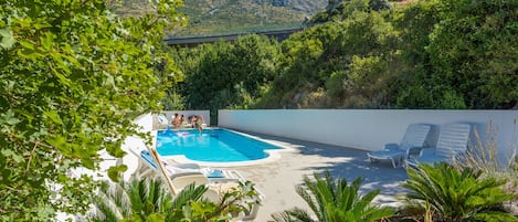 Pool with deck chairs on disposal 