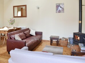 Cosy living area with wood burner | Guillemot Cottage - Manor Farm Cottages, Buckton, near Flamborough