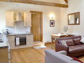 High ceilings, with beams give character to this open plan style living/ kitchen/ diner | Guillemot Cottage - Manor Farm Cottages, Buckton, near Flamborough