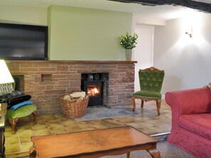 Good-sized, beamed living room with a wood burner | Smithy House, Bampton Grange, near Pooley Bridge