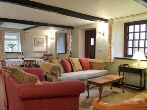 Good-sized, beamed living room with a wood burner | Smithy House, Bampton Grange, near Pooley Bridge
