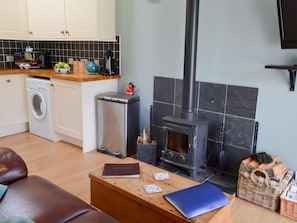 Living room with wood-burning stove | Saddle Room - Higher Farm, Martin, Fordingbridge