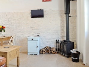 Wood-burning stove in lounge area | The Dairy - Milton End Farm Barns, Arlingham, near Frampton-on-Severn