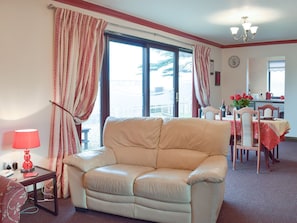 Comfortable sofa and patio doors to the garden | Elm View - Elm Cottages, Cwmbach, near Whitland