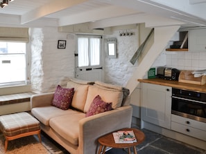 Open plan living space with slate floor & wood beams | Haven Cottage, Port Isaac