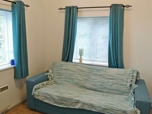 Cosy living area with double futon bed | The Pocket Watch, Seatown