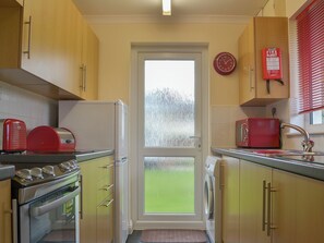 Galley style kitchen with garden access | Talland Bay - Rosecraddoc Holiday Village, Liskeard