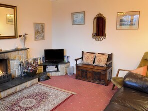 Comfortable living room with open fire | Culcharry Cottage, Cawdor, Nairn