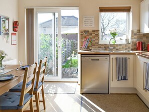 Airy kitchen/diner with patio door to garden | Signals Court, Scarborough