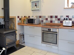 Well equipped kitchen with a cosy wood burner | Manor House Dairy Cottage, East Ayton, near Scarborough